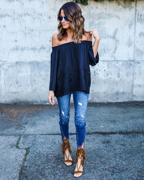 With navy blue off the shoulder top and distressed jeans