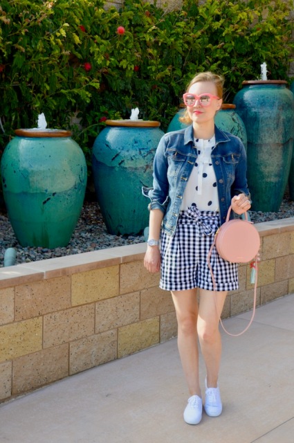 With polka dot shirt, denim jacket, pale pink bag and white sneakers