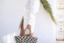 With white belted dress and printed tote bag