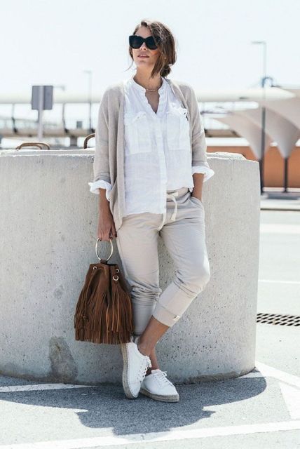 With white button down shirt, white flat shoes, brown fringe bag and gray cardigan