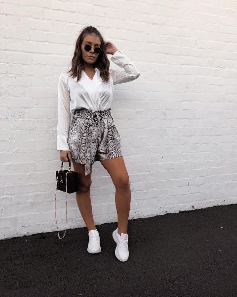 With white wrap shirt, black bag and white sneakers