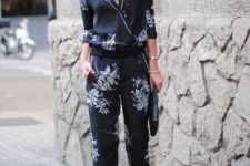 a black floral pajamas suit, bblack heels and a clutch for a lovely day to night look