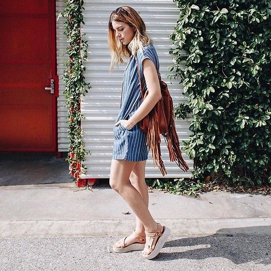 a blue and white striped mini dress with short sleeves, nude sporty sandals, a brown fringe bag