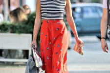 a bold look with a striped sleeveless top, a red printed midi, red heels and a silver clutch