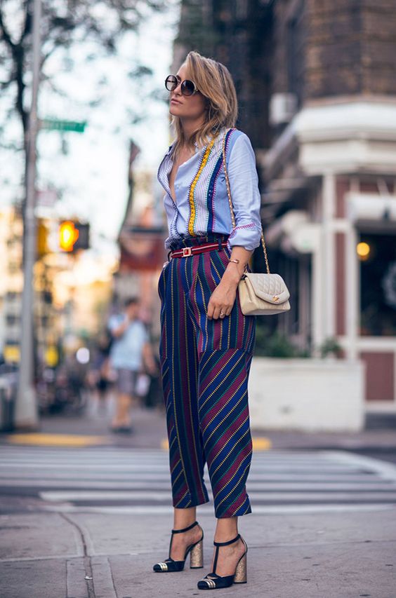 a bright striped shirt, bold striped cropped pants, block heels and a neutral bag for a party