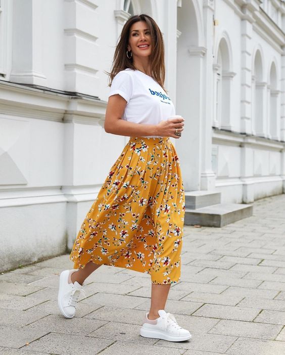 a casual look with a white printed tee, a yellow floral midi, white sneakers is perfect for every day