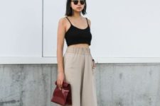 a comfortable everyday look with a black crop top, neutral linen culottes, black sporty sandals and a brown bag