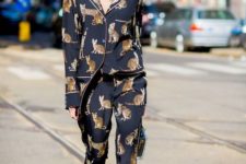 a gorgeous look with a black cat printed pajamas suit, black and gold shoes and a clear bag