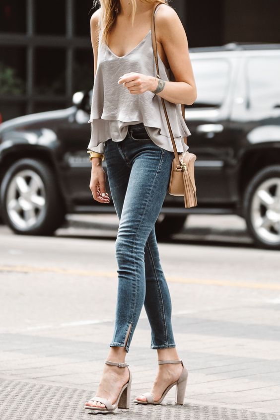 a grey layered tiered top, blue cropped skinnies and dove grey minimalist heeled sandals plus a neutral bag