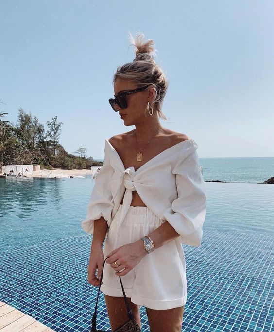 a light vacation look with an off the shoulder tied crop tp and shorts plus a statement necklace