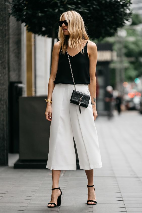 a monochromatic summer look with a black tank top, white culottes, black minimalist heels and a black bag