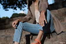 a neutral tank top, blue cropped jeans, a plaid blazer, orange sporty sandals for a colorful accent