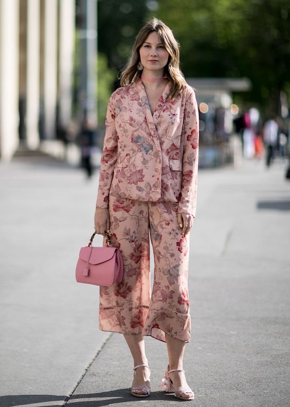 a pastel pink floral pajamas suit with cropped pants, pink floral shoes and a bright pink bag
