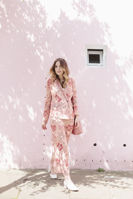 a pink floral pyjamas suit with white block heels and a pink bag for a comfy and chic look
