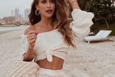 a sexy beach party look in white with an off the shoulder crop top and layered mini skirt
