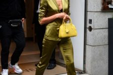 a silk green pajamas suit with skinny pants, cutout heels and a lemon yellow mini bag