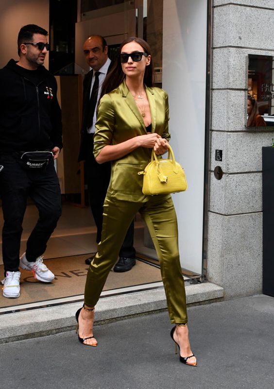 a silk green pajamas suit with skinny pants, cutout heels and a lemon yellow mini bag