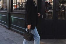 a striped top, a black blazer, blue jeans, black sporty sandals, a black woven bag for a casual outfit