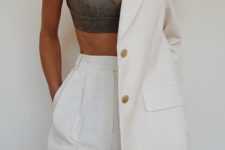 a stylish oversized creamy suit with a long blazer and high waisted pants plus a grey bra crop top
