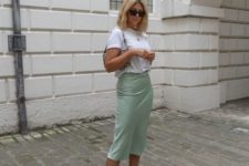 a summer look with a white tee, a light green satin midi, nude square toe heels and a small bag