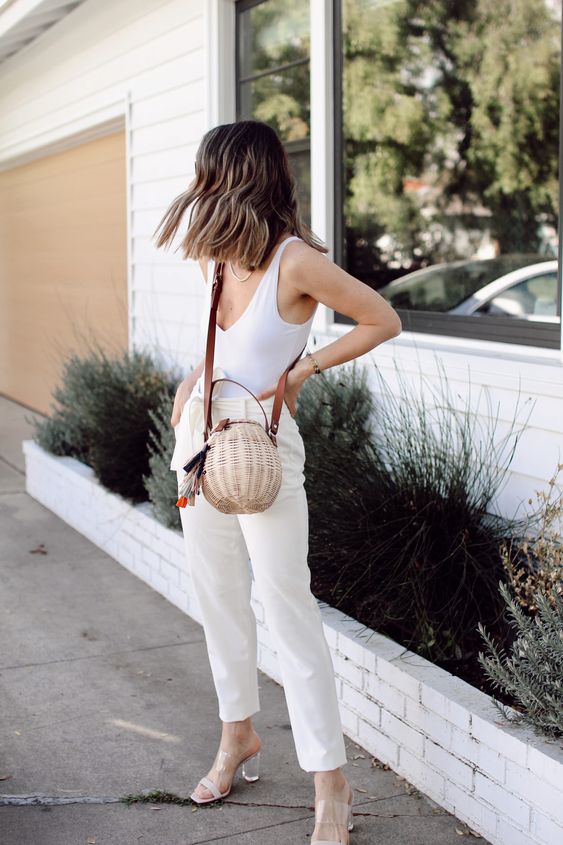 a summer monochromatic look with a white top, white paperbag pants, acrylic shoes and a round basket bag