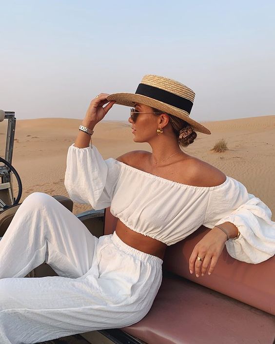 a vacation look in white with an off the shoulder crop top with long sleeves and wideleg pants