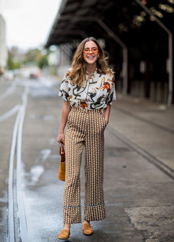 a whimsy printed shirt, polka dot pants, mustard mules and a matching bag for an extra bold look