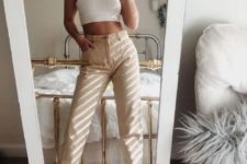 a white halter neckline crop top, tan jeans, white trainers for a comfy summer look