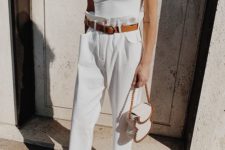 a white one shoulder top, white paperbag pants, a brown belt, brown heels and a white quirky bag