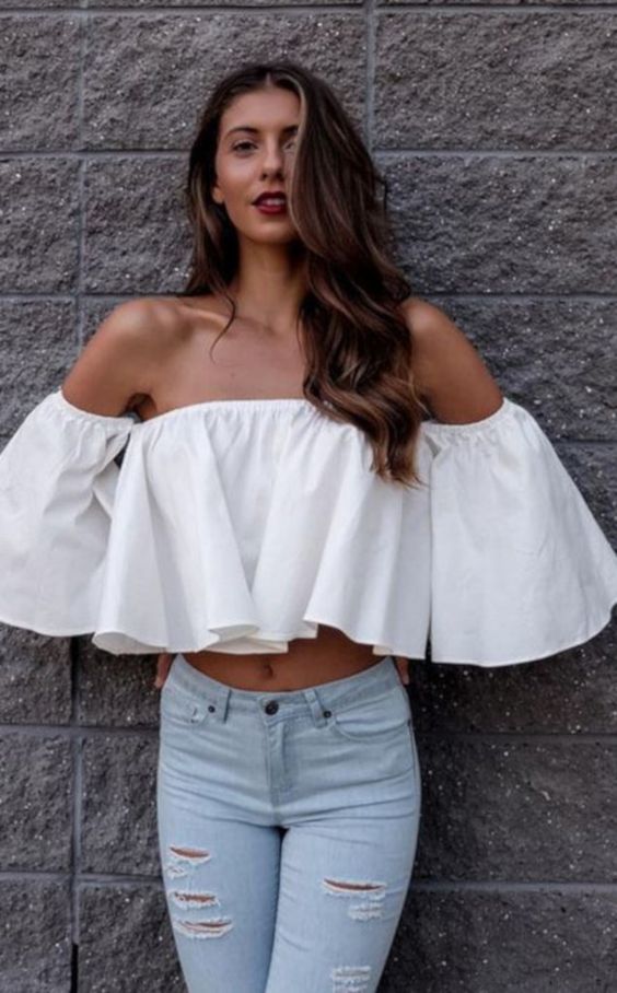a white ruffle off the shoulder crop top and light blue ripped skinnies for a sexy look