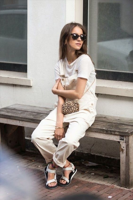 a white tee, a neutral overall, silver sporty sandals and an animal print bag for a chic and comfy outfit