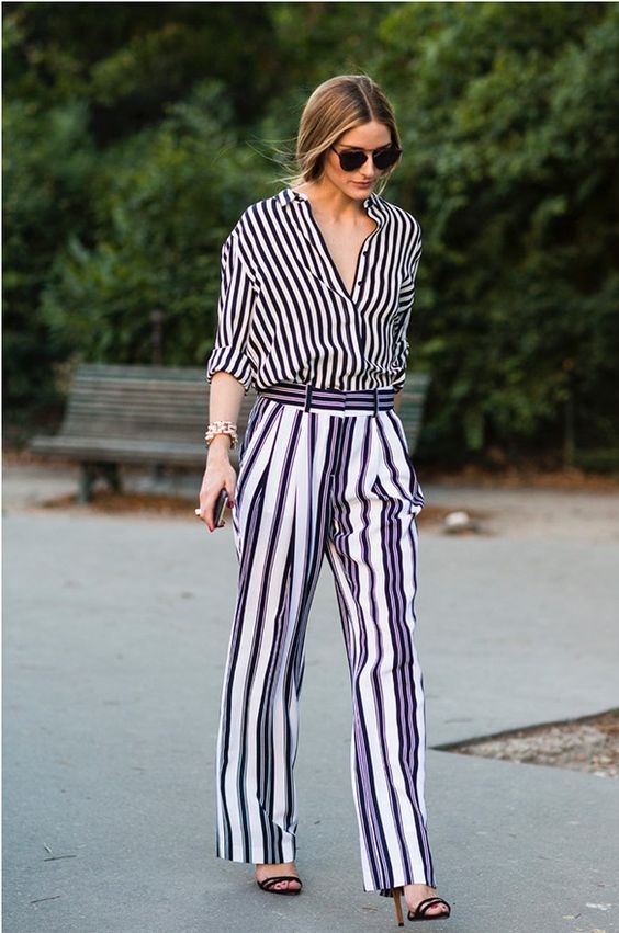 a work look with a striped shirt and pants, black heels and a statement bracelet by Olivia Palermo