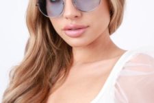 oversized round blue sunglasses in a thin frame show off pastels and a trendy size