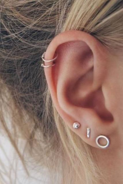 elegant ear accessorizing with minimalist gold studs and gold hoop earrings in the double helix piercing