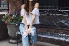 With beige hat, distressed jeans and white shoes