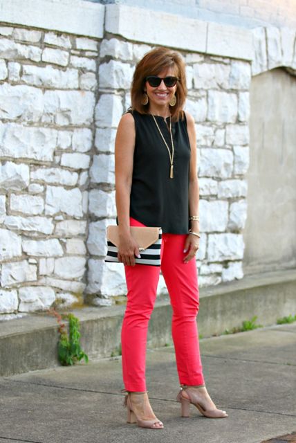 With black sleeveless top, red pants and beige heeled shoes