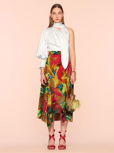 With colorful floral midi skirt, feather bag and red lace up high heels