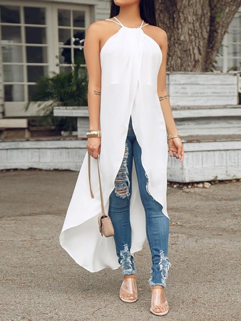 With distresssed skinny jeans, transparent sandals and beige chain strap bag