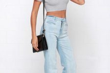 With gray crop top, black bag and black pumps