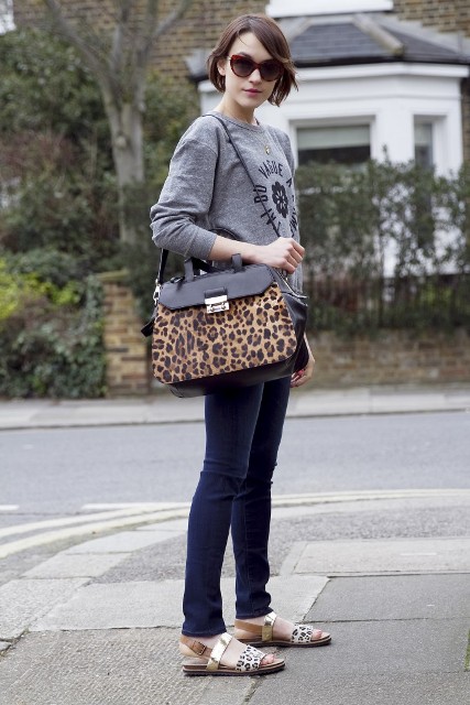 With gray sweatshirt, skinny jeans and leopard printed bag