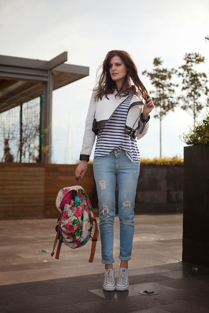 With striped shirt, white and black crop jacket, cuffed jeans and sneakers
