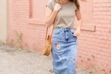 With t-shirt, straw rounded bag and brown flat sandals