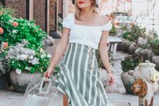 With white blouse, transparent bag, striped ruffled skirt and mules