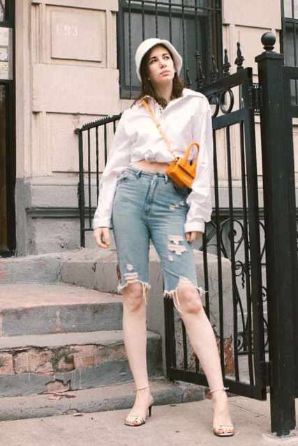With white long sleeve shirt, distressed denim bermuda shorts, yellow bag and ankle strap shoes