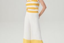 With yellow and white sleeveless top and white low heeled mules