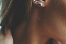 a beautiful silver feather climber earring is a lovely accessory for adding a boho touch to the look