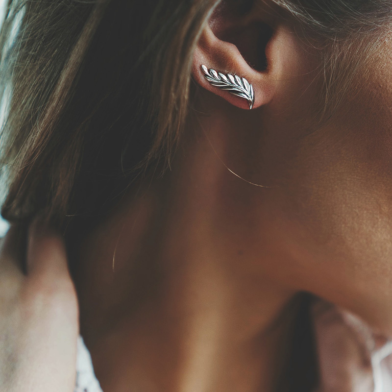 A beautiful silver feather climber earring is a lovely accessory for adding a boho touch to the look