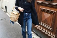 a black top, a black thin stripe blazer, blue jeans, tan Chelsea boots and a basket bag