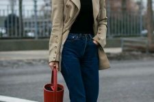 a black turtleneck, a tan vintage blazer with button sleeves, blue jeans, black sock boots and a red bucket bag