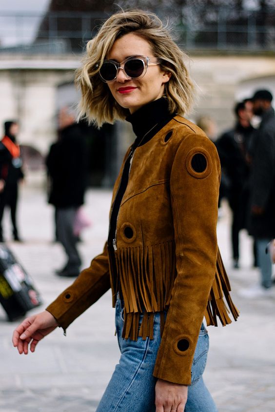 a black turtleneck, blue jeans and a rust-colored fringe cropped suede jacket for the fall